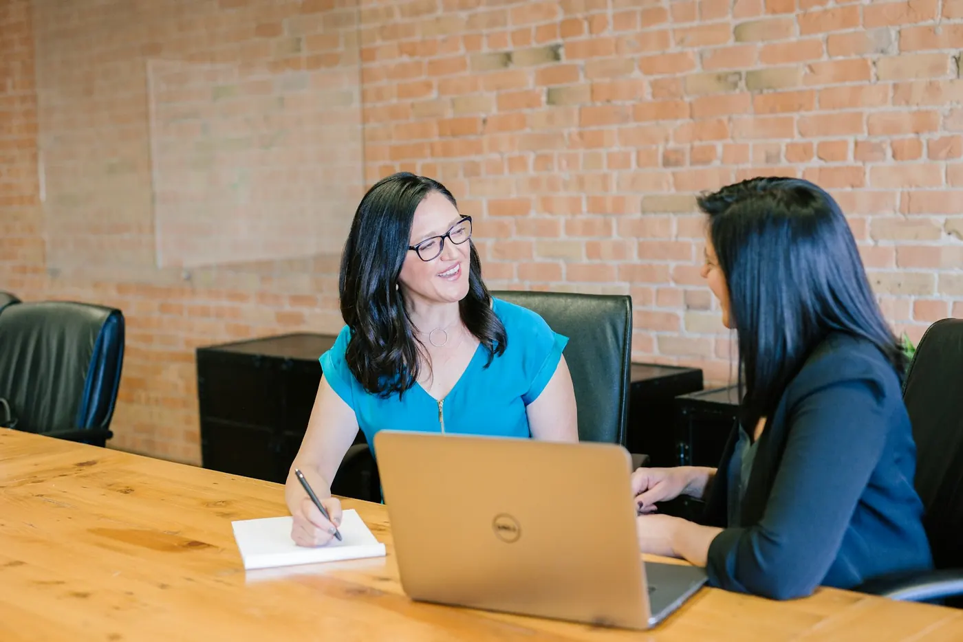Two advisers talking through a plan at a desk